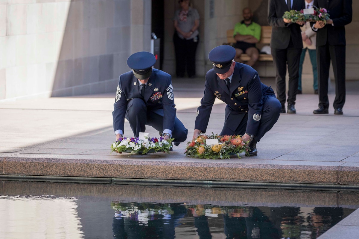 Military members lay wreaths.